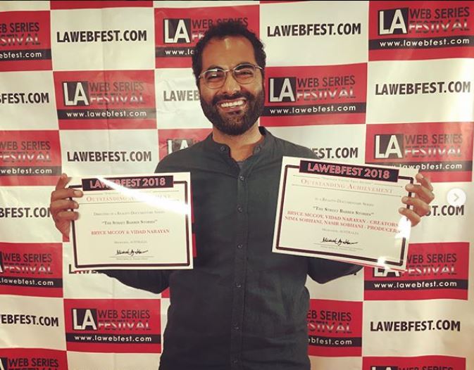 Vidad holding two awards at the LA WebFest for The Streets Barber Web Series